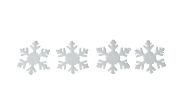 Four white, frosty, star-shaped objects aligned horizontally on a black backdrop - Powered by Adobe