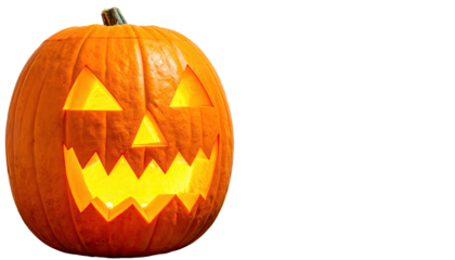 A carved, glowing orange gourd with triangular eyes, nose, and jagged mouth