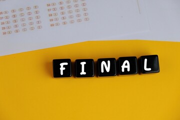 the words FINAL EXAM on yellow background. the concept of answering quizzes or quiz games