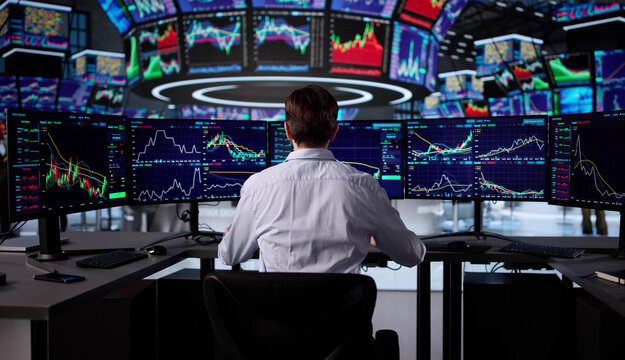 Senior Trader Analyzing Market Data On Computer