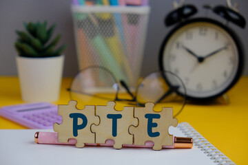 pte - text on wooden cubes stationery. Pearson Test of English, a computer-based English language...