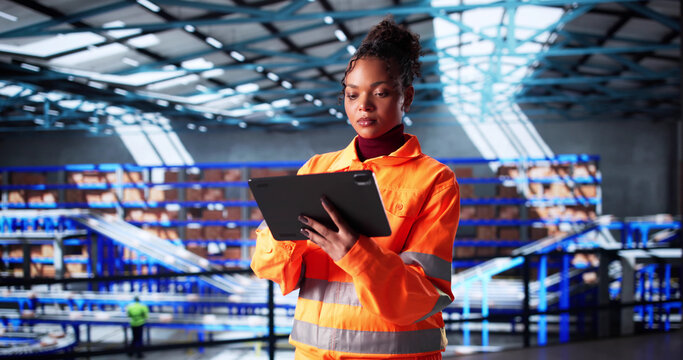 Female African-American OSHA Inspector Audits Logistic Warehouse - Powered by Adobe