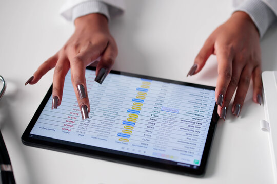 Woman Using Tablet For Medical Billing And Coding Audit In Hospital