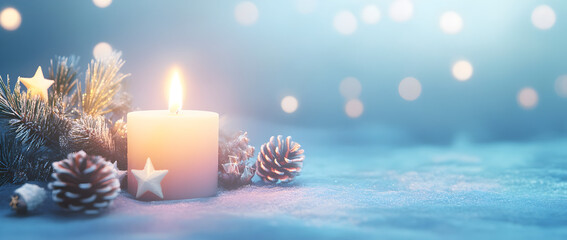 A soft blue background with a large, lit candle in the center, surrounded by Christmas decorations like small white stars and pine cones