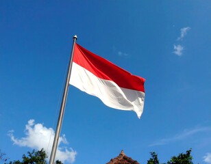 Indonesian Flag Waving in the Wind Against a Blue Sky