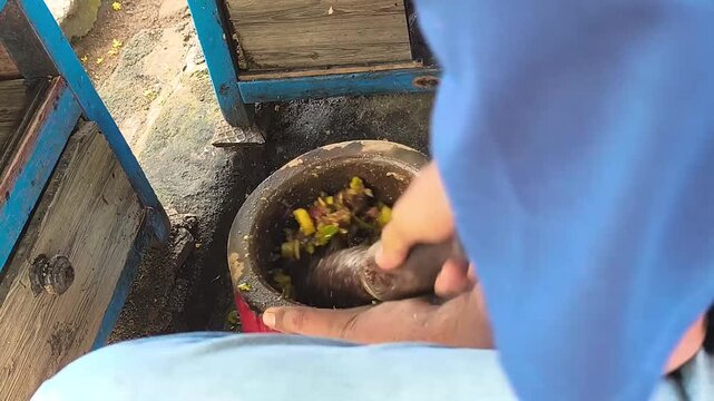 making rujak, an Indonesian traditional dish made from fruits mixed with spices by crushing them