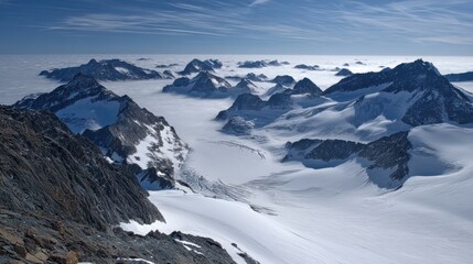 Majestic Peaks Rise Above the Sea of Clouds in a Breathtaking High Angle Winter Landscape with Clear Blue Sky