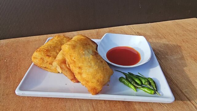 fish and chipsRisole,Rissoles,Risol is snack fiiled with vegetables,smoked beef,sausage,cheese,mayonnaise sauce,wrapped in risol skin and bread crumbs served with green cayenne pepper and chili sauce 