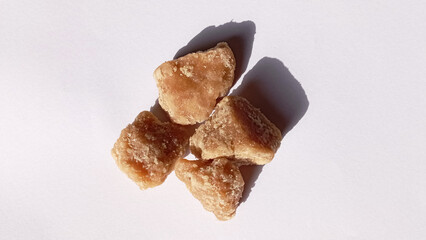Jaggery brown sugar cubes. Sugar can jaggery on isolated white background