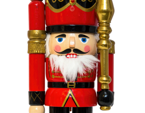 Close-up of a wooden soldier figurine in vibrant red and gold attire