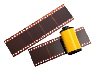 Rolled canister of undeveloped analog film beside strips of film. Isolated on black