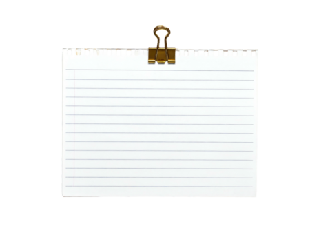 A ruled white notepad sheet held by a gold-colored metal clip against a black background