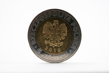 Polish 5 zloty coin 2016 with national eagle emblem on white background.