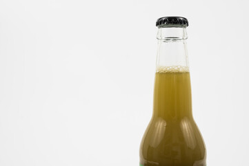 Close-up of a bottle with a greenish liquid and foam at the top.