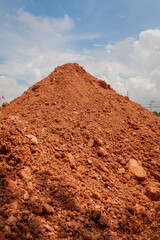 Construction action red dirt pile in open field landscape clear sky environment aerial view