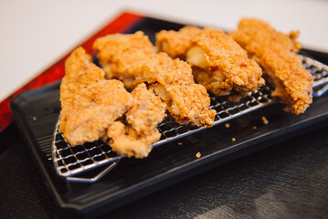 Crispy fried chicken on sieve served. top view. Flat lay.