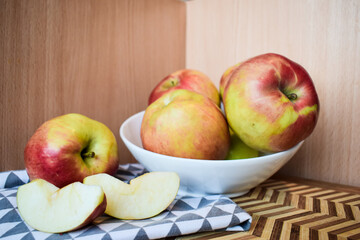 Fresh Red and Yellow Apples in Bowl on Wooden Background