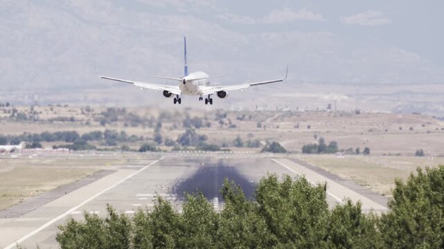 Plane crosswind landing in Madrid Barajas international airport in a hot summer day 4k video