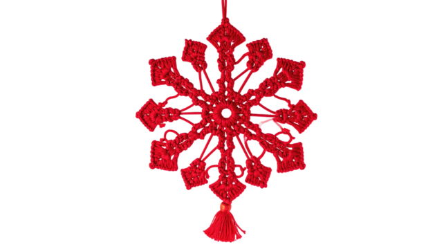 Red, ornate, snowflake-like ornament with intricate details, hanging against black