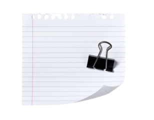 Lined paper with a binder clip, partial curl, and hole punches, isolated on black