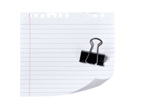 Lined paper with a binder clip, partial curl, and hole punches, isolated on black