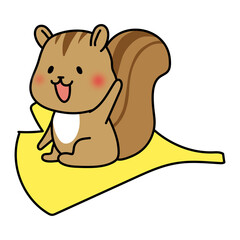 大きな落ち葉に乗るリス