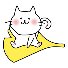 大きな落ち葉に乗る白い猫