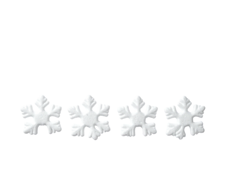 Four white, delicate, symmetrical shapes resembling snowflakes on a stark black backdrop