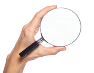 A hand holds a magnifying glass, round lens facing the viewer, isolated on black