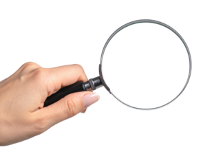 A hand holding a magnifying glass on a black background, ready to observe