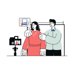 Woman Poses for Camera While Man Adjusts Her Pose in a Studio Setting with a Softly Lit Backdrop for Photography Session