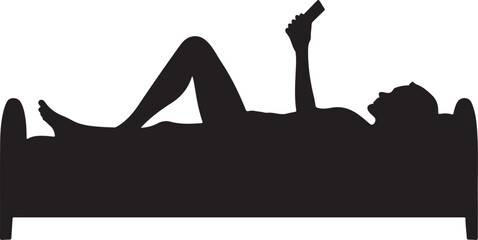 Silhouette of person lying in bed using smartphone