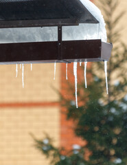 A roof has icicles hanging from it