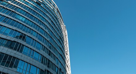 Sleek, contemporary high-rise office building against a vivid azure sky, representing innovation, prosperity, and a bright future ,upwards ,office ,high-rise