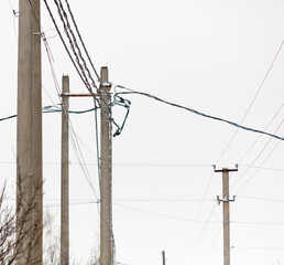 A power line pole with a wire hanging down