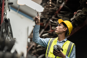 Portrait Asia man technician or engineer checking auto part or car part at car part warehouse  © chachamp