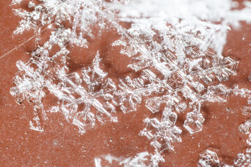 A snowflake is on a red surface