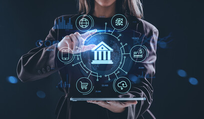 Digital banking concept with hologram interface showing finance icons and technology interaction on futuristic background in innovation context.