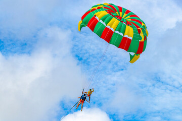 Patong Beach Phuket with parachute sport and parasailing activity Thailand.