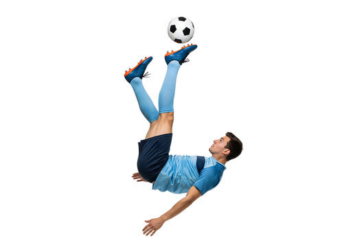 A soccer player in mid-air performs a skillful overhead kick with a soccer ball. He demonstrates agility and athleticism with every move.