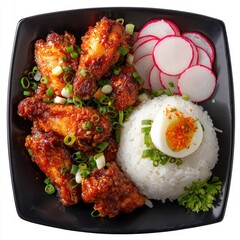 Spicy chicken wings, rice, and egg, served on a dark plate