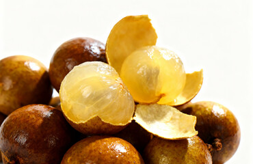 Fototapeta premium Close-up of juicy, peeled longan fruit and whole longans, showcasing the sweet, translucent flesh and unique texture