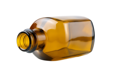 Empty amber glass bottle with screw top lying on its side against a black background