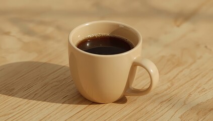 Obraz premium Beverage rests in a ceramic cup, filled with a dark liquid, positioned on a wooden surface, casting a visible shadow, highlighting the light tones and the warm ambiance.