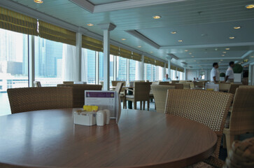 Elegant buffet self-service casual informal dining restaurant onboard luxury cruiseship cruise ship liner with tables and seats