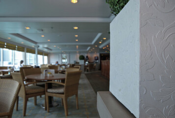 Elegant buffet self-service casual informal dining restaurant onboard luxury cruiseship cruise ship liner with tables and seats