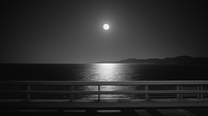 from a bridge, looking out over a calm ocean illuminated by bright moonlight