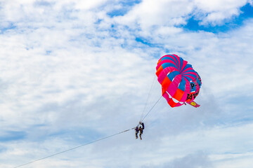Patong Beach Phuket with parachute sport and parasailing activity Thailand.