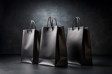 Three elegant black paper shopping bags arranged on a dark textured surface with dramatic lighting