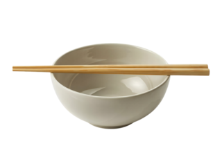 A plain, light-colored ceramic bowl sits with a pair of wooden chopsticks resting horizontally across its rim.